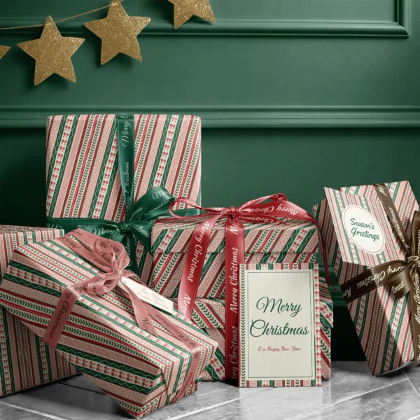 Stack of presents in ribbon stripe paper with ribbons and a Merry Christmas card by a dark green wall