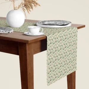 Sage tree Christmas table runner hanging over the end of a walnut dining table, close-up