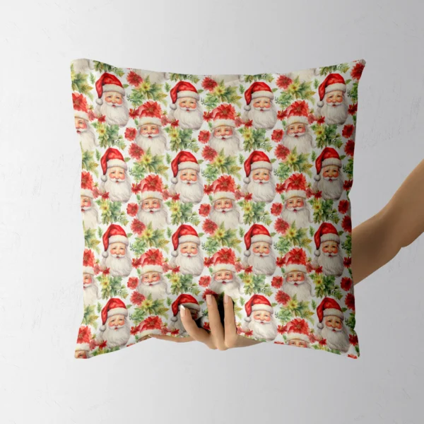 A hand lifting the white watercolor Santa poinsettia pillow