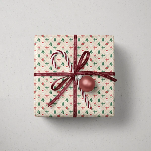 Top view of a gift in Santa lattice paper with a ribbon, candy canes and a bauble
