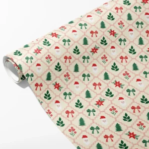 Roll of cream wrapping paper with Santa faces, poinsettias, bows and trees in a wavy red lattice, partly unrolled on white