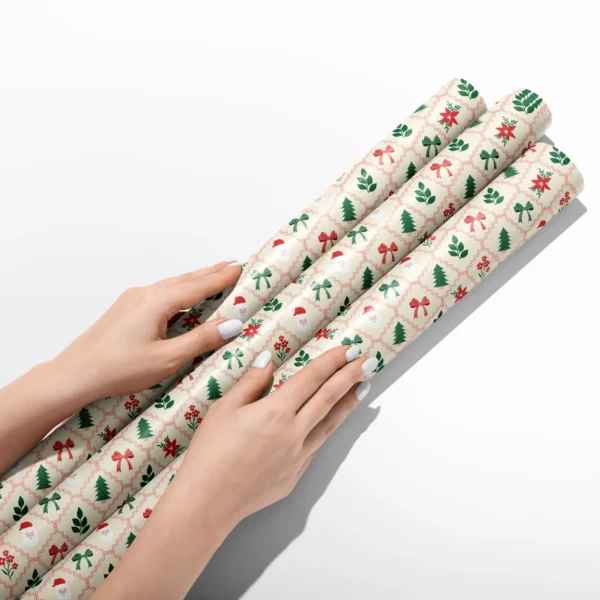 Hands smoothing three rolls of Santa lattice wrapping paper on a white table