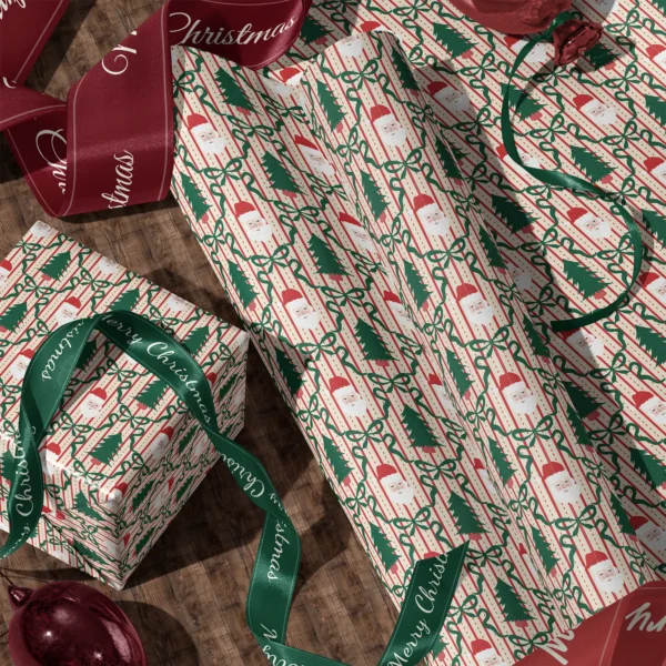 Rolls of Santa trellis gift wrap and a wrapped box with satin ribbons on a wooden floor