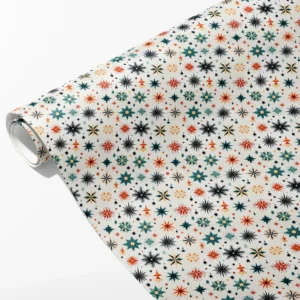 Roll of off-white wrapping paper with folk starbursts in teal, rust orange and near-black, partly unrolled on white