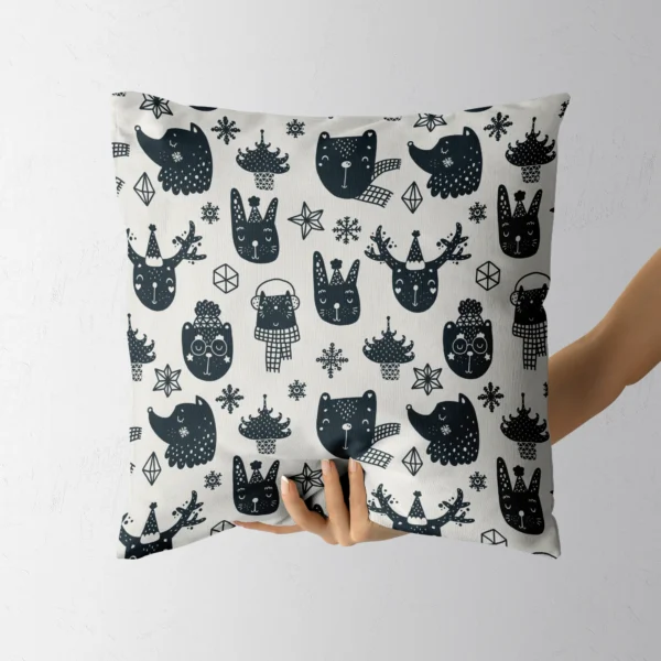Scandi animal Christmas pillow resting in a hand