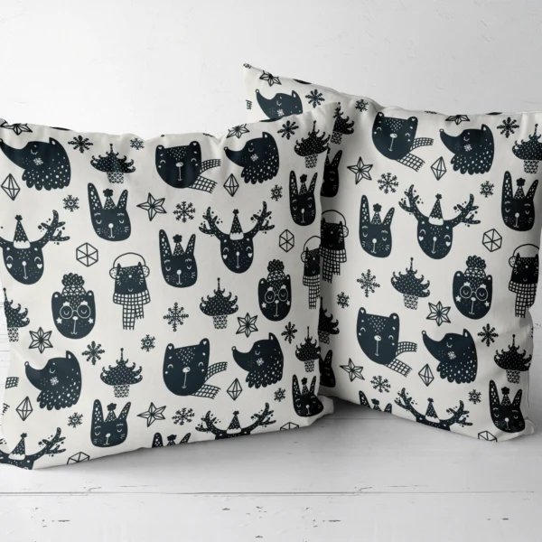Two woodland animal throw pillows sitting side by side