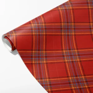 Roll of scarlet plaid wrapping paper with open red panes and bands of fine gold, blue and green stripes, partly unrolled