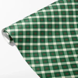 Roll of green, sage and cream gingham wrapping paper with a small red snowflake in each dark square, partly unrolled on white