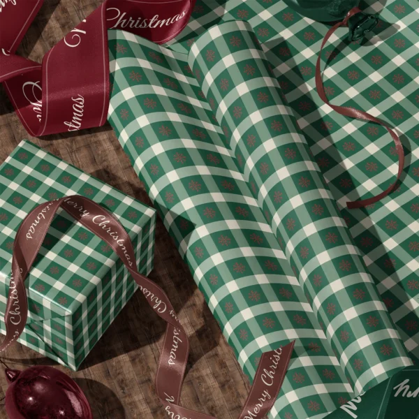 Rolls of snowflake gingham gift wrap and a wrapped box with satin ribbons on a wooden floor