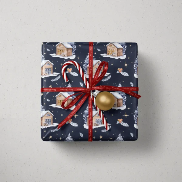 Top view of a gift in navy night cabin paper with a red ribbon, a candy cane and a gold bauble