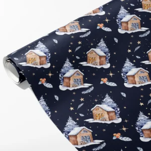 Roll of navy wrapping paper with watercolor snowy cabins, firs, orange berries and gold stars, partly unrolled on white