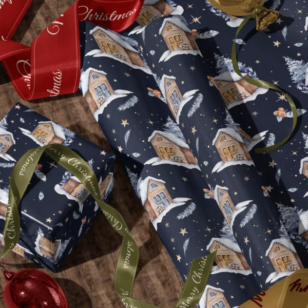 A sheet of navy night cabin gift wrap and a wrapped box with red and green satin ribbons on a wooden floor