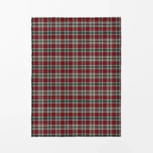 Burgundy and green tartan plush blanket laid flat on white, top view