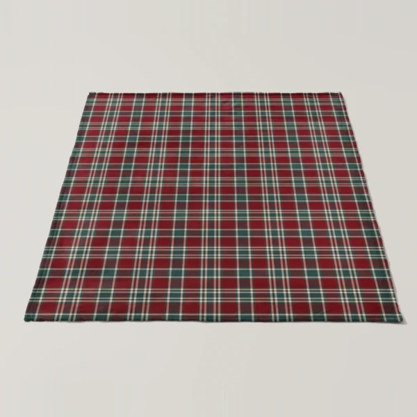 Burgundy plaid velveteen blanket spread flat on a pale floor