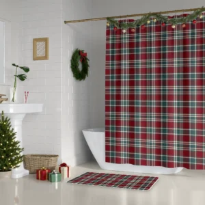 Burgundy and green tartan shower curtain hanging beside a white tub in a bathroom decorated for Christmas
