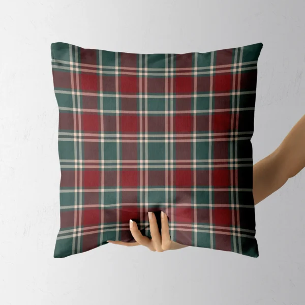 Hand holding the square burgundy plaid throw pillow