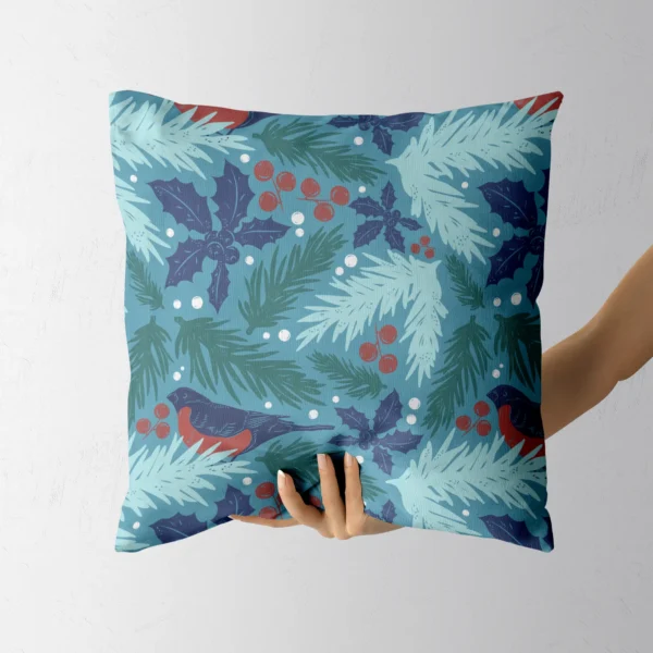 Hand lifting the teal pillow with a red-breasted bullfinch