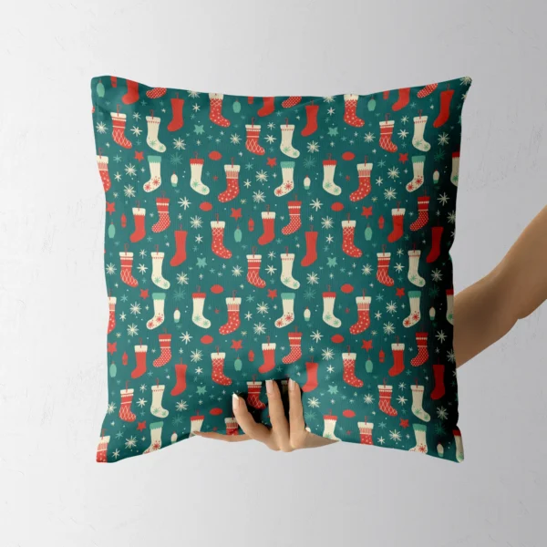 Teal stocking Christmas pillow resting in a hand