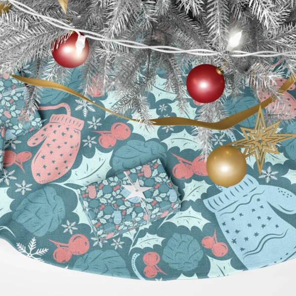 Detail of a pale blue mitten with wavy bands beside mint holly and coral berries
