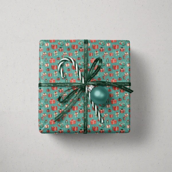 Top view of a gift in teal gift box paper with a ribbon, a candy cane and a bauble