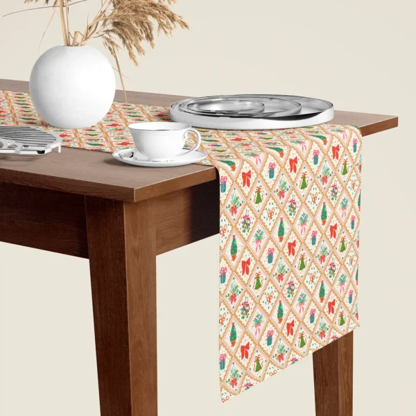 Vintage gold tile Christmas table runner hanging over the end of a walnut dining table, close-up
