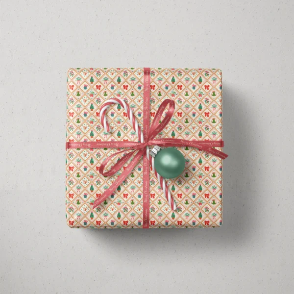 Top view of a gift in vintage gold tile paper with a ribbon, candy canes and a bauble