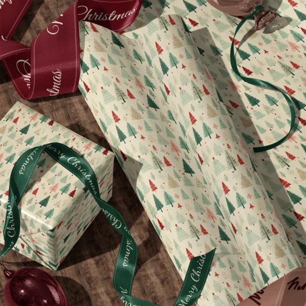 A sheet of cream vintage forest gift wrap and a wrapped box with satin ribbons on a wooden floor