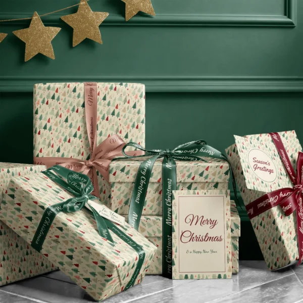 Stack of presents in cream vintage forest paper with ribbons and a Merry Christmas card by a dark green wall