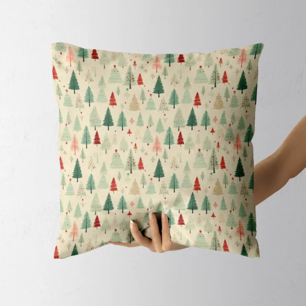 A hand lifting the cream forest Christmas pillow
