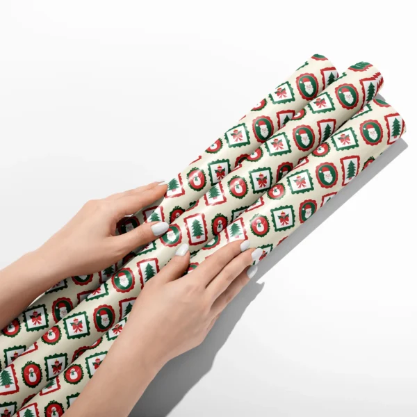 Hands smoothing three rolls of vintage frames wrapping paper on a white table