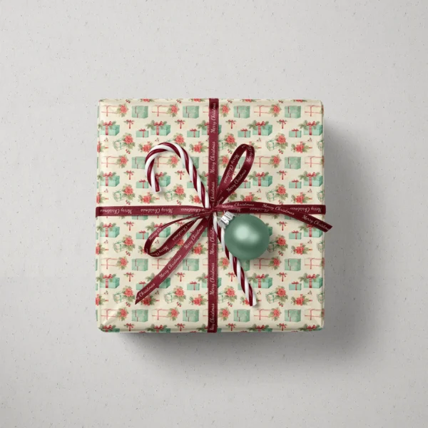 Top view of a gift in poinsettia and gift paper with a ribbon, a candy cane and a bauble