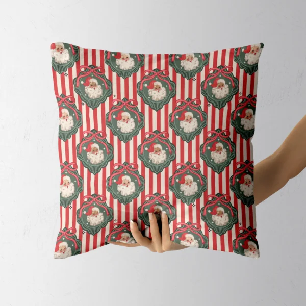 A hand holding the striped vintage Santa throw pillow