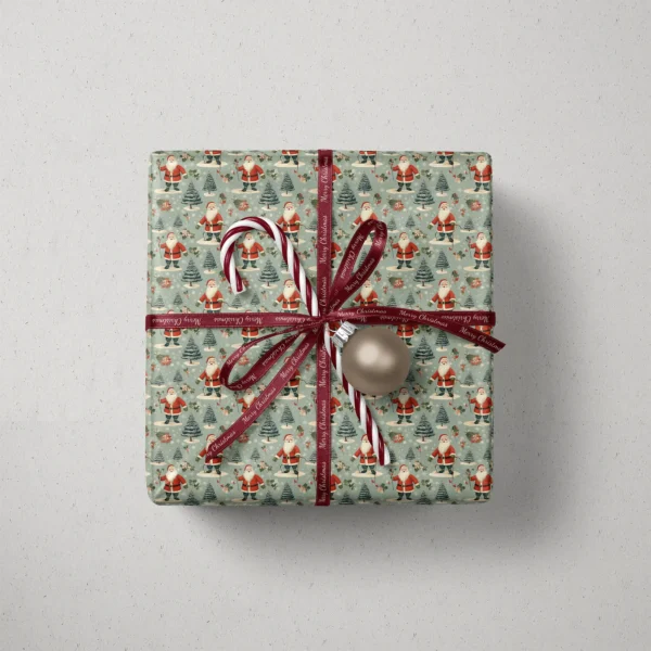 Top view of a gift in sage vintage Santa paper with a ribbon, a candy cane and a bauble