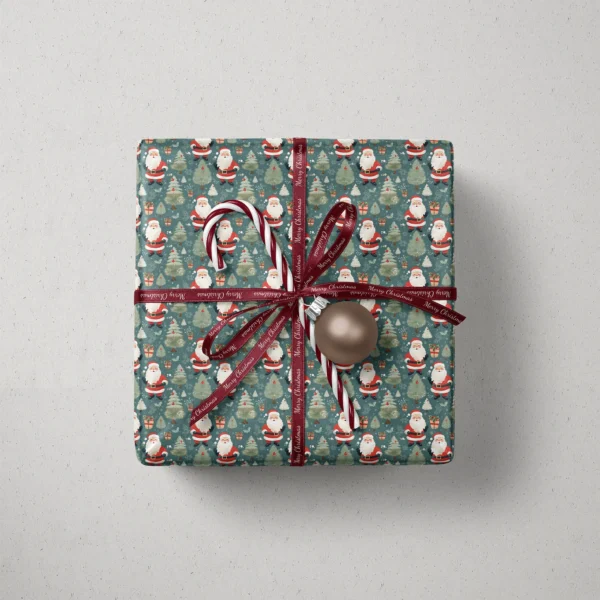 Top view of a gift in slate vintage Santa paper with a ribbon, a candy cane and a bauble