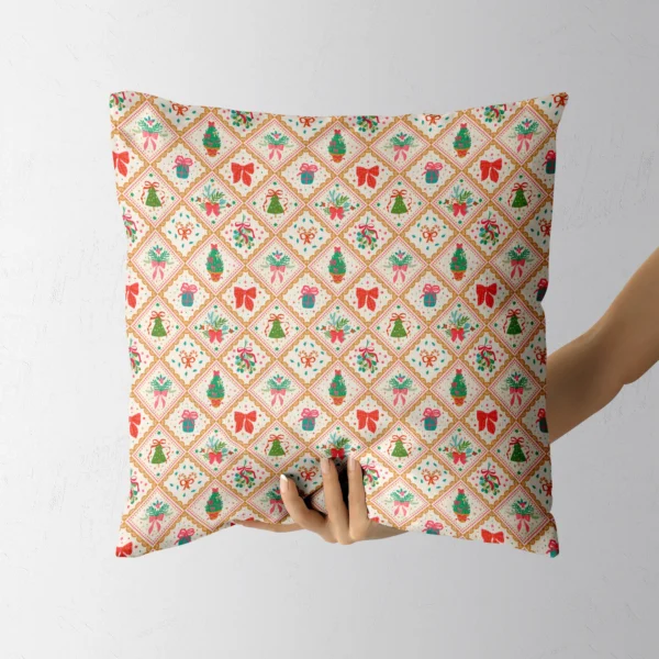 A hand holding the cream pillow with gold diamond tiles