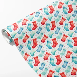 Roll of white wrapping paper with red, turquoise and blue watercolor stockings and tiny stars, partly unrolled on white