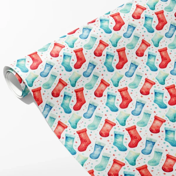 Roll of white wrapping paper with red, turquoise and blue watercolor stockings and tiny stars, partly unrolled on white