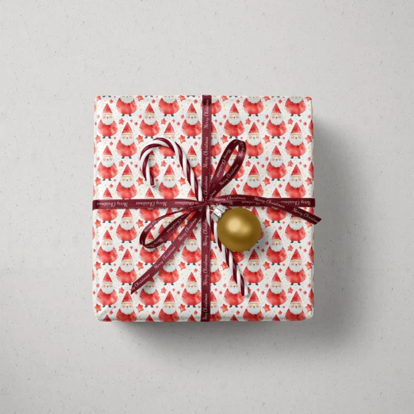 Top view of a gift in red watercolor Santa paper with a ribbon, a candy cane and a bauble