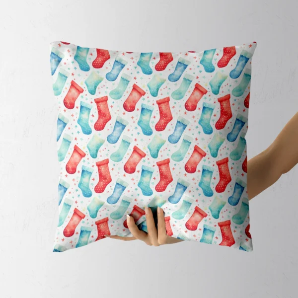 Hand holding the square watercolor stocking pillow