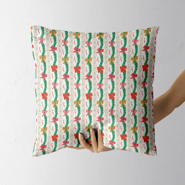 Hand holding the white pillow with wavy pine garlands and bows