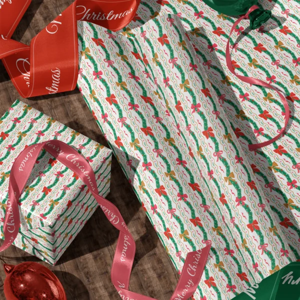 Rolls of wavy garland gift wrap and a wrapped box with satin ribbons on a wooden floor