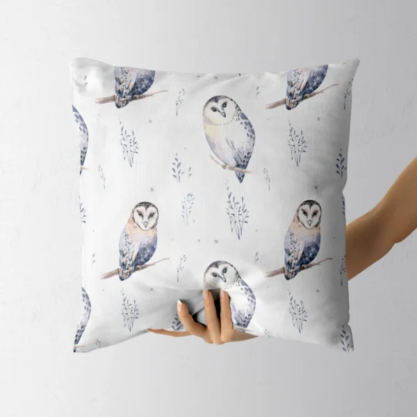 Hand holding the white pillow with perched watercolor owls