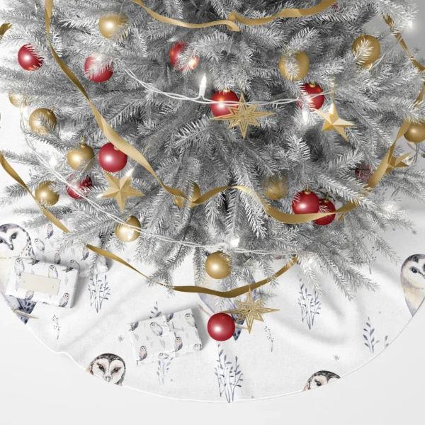 Watercolor owl tree skirt under a lit tree with wrapped presents