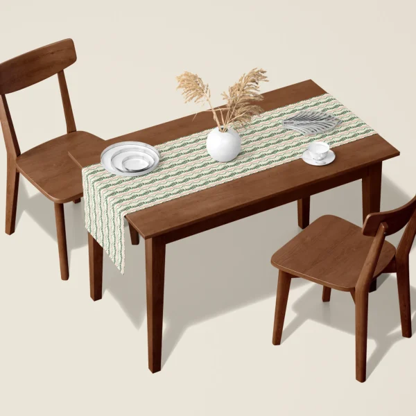 Winding berry vine Christmas table runner on a walnut dining table with two wooden chairs