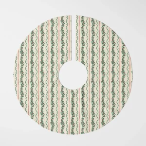 Winding berry vine tree skirt laid flat, curving green vines and red berries on cream
