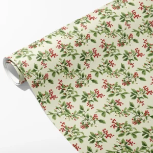 Roll of cream wrapping paper with sprigs of red berries, small white blossoms and green leaves, partly unrolled on white